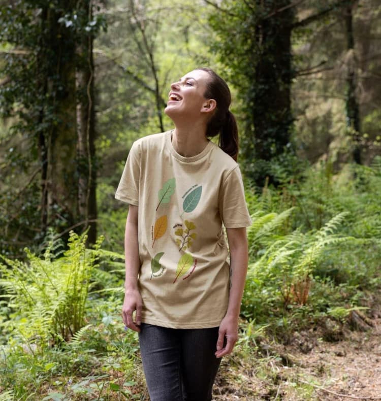 A woman walking through a forest with her eyes closed