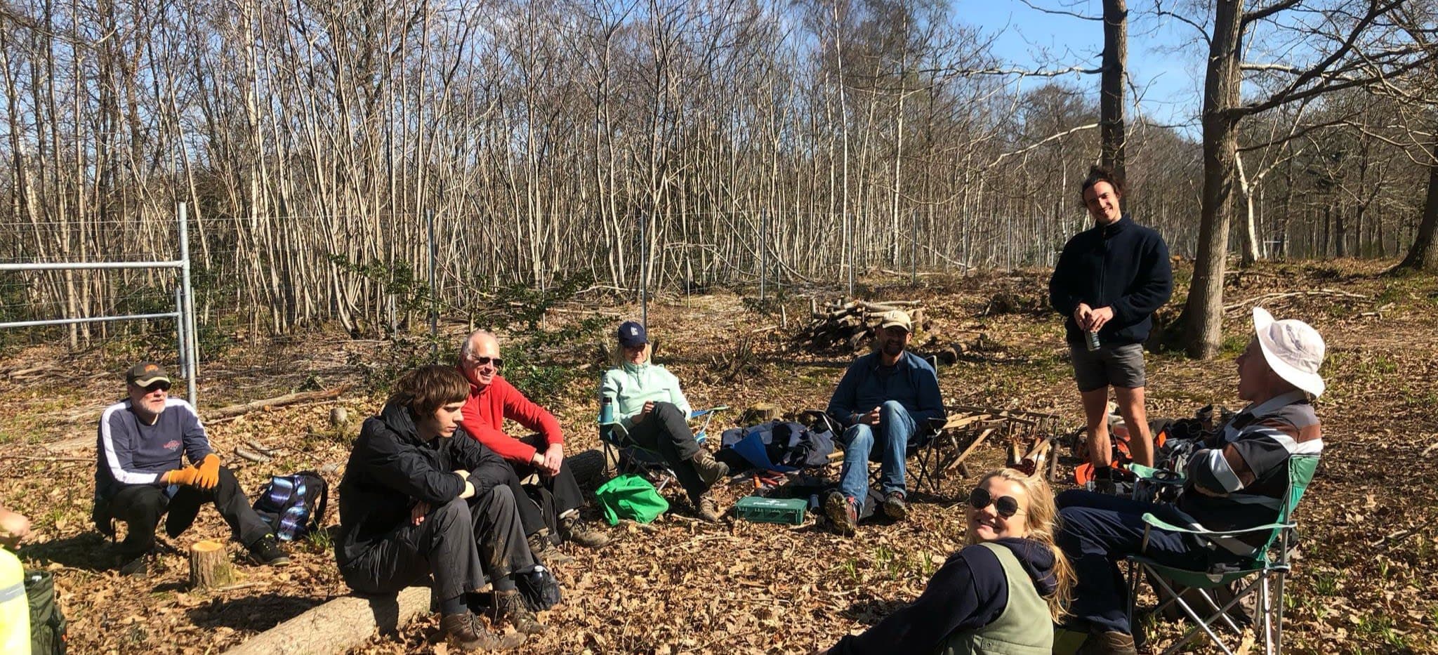 A group of people sitting in the woods