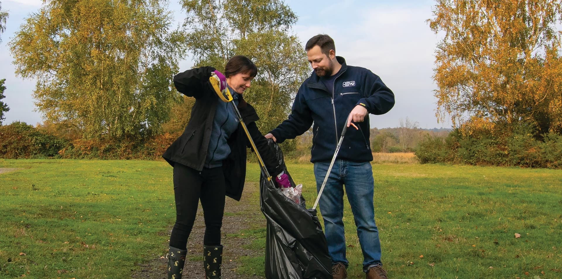 A couple of people that are standing in the grass