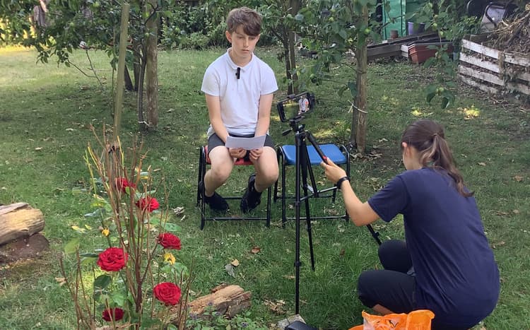 A couple of people sitting in chairs in a field