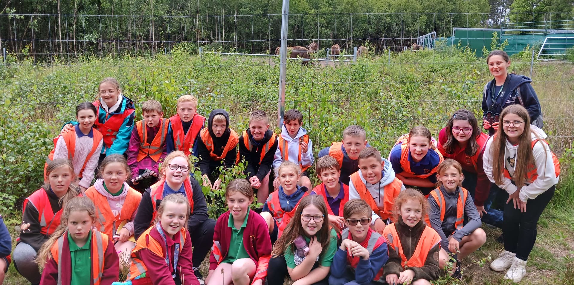 A group of children in life jackets posing for a picture