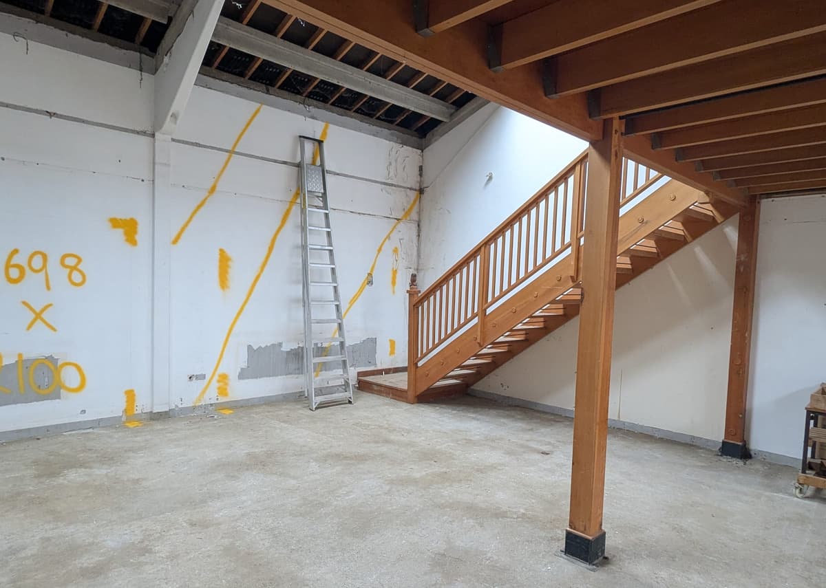 A room with a staircase and a bench in it