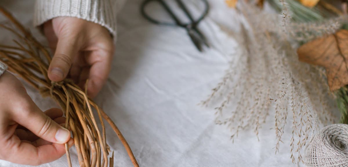 A person is making a wreath out of twigs