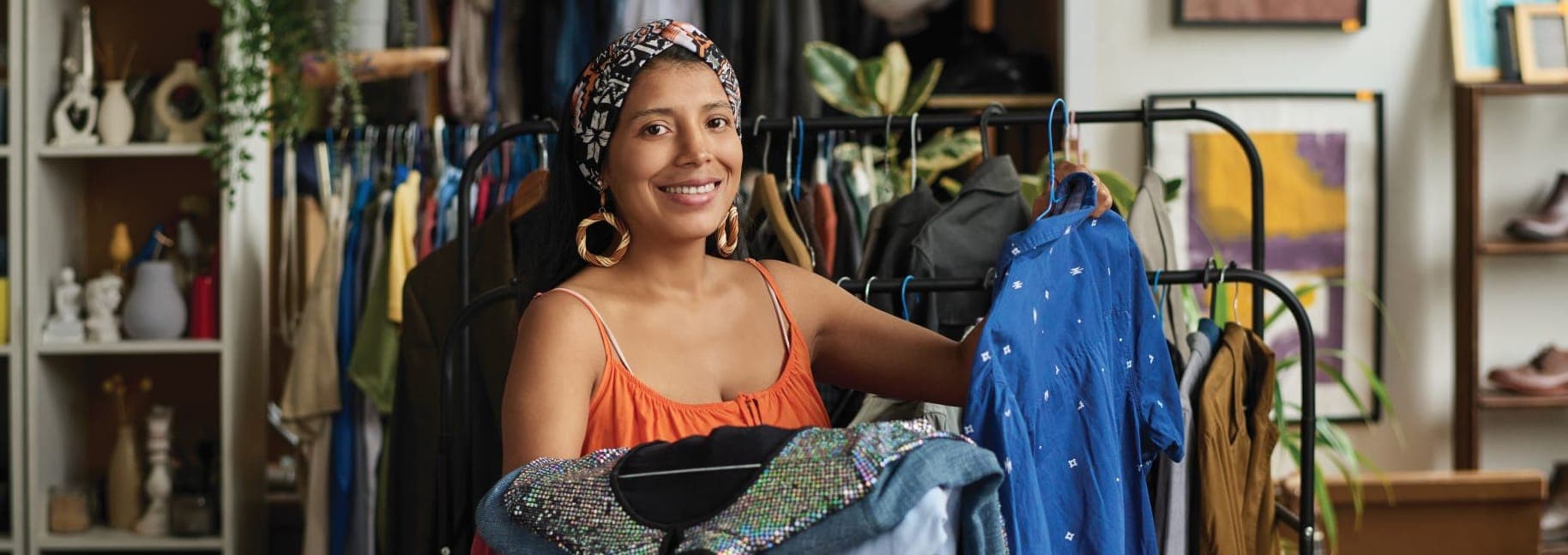 A woman standing in front of a rack of clothes
