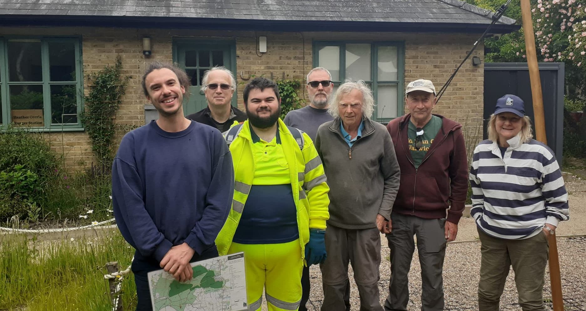 A group of people standing in front of a house