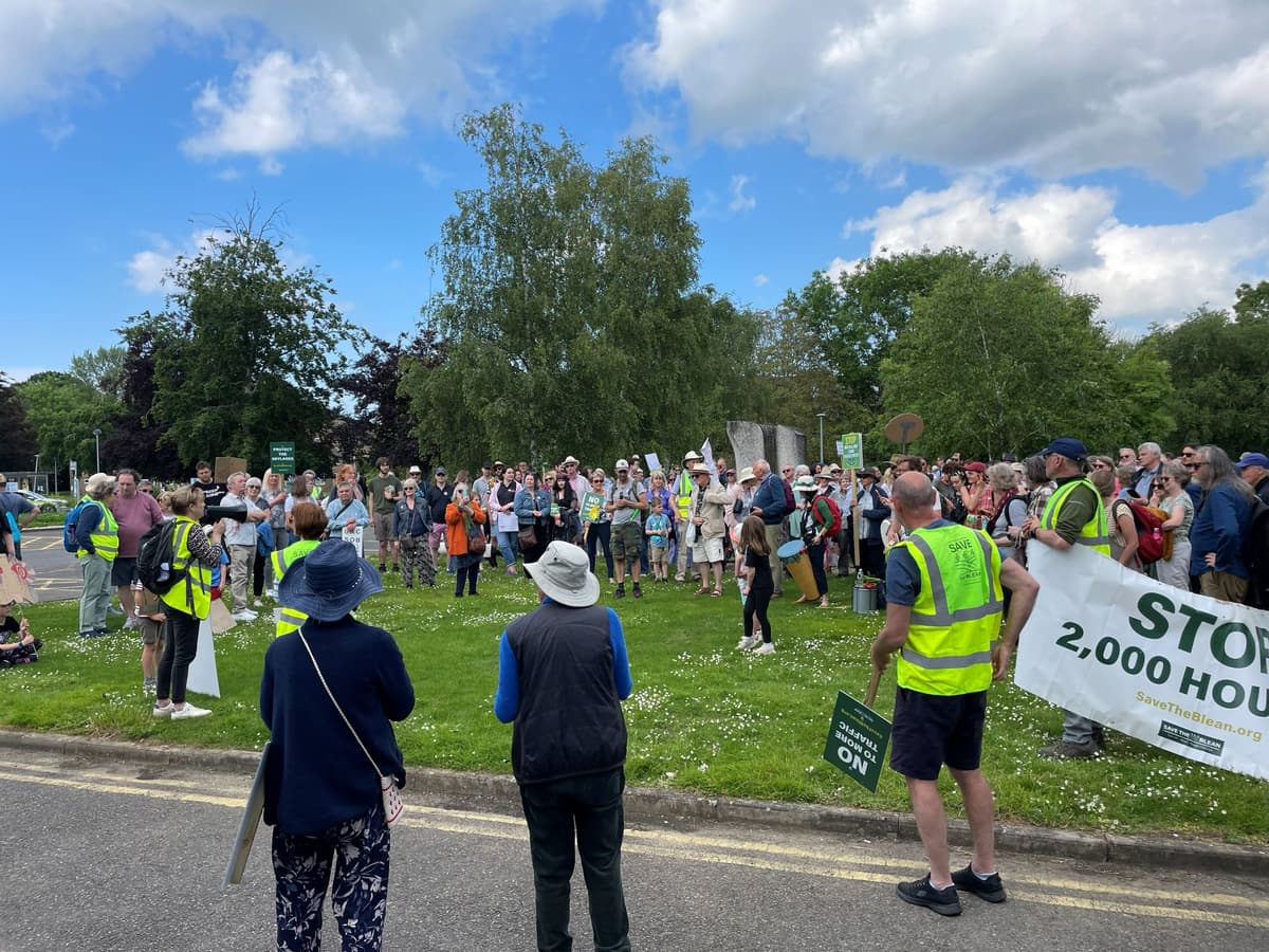A group of people standing on the side of a road
