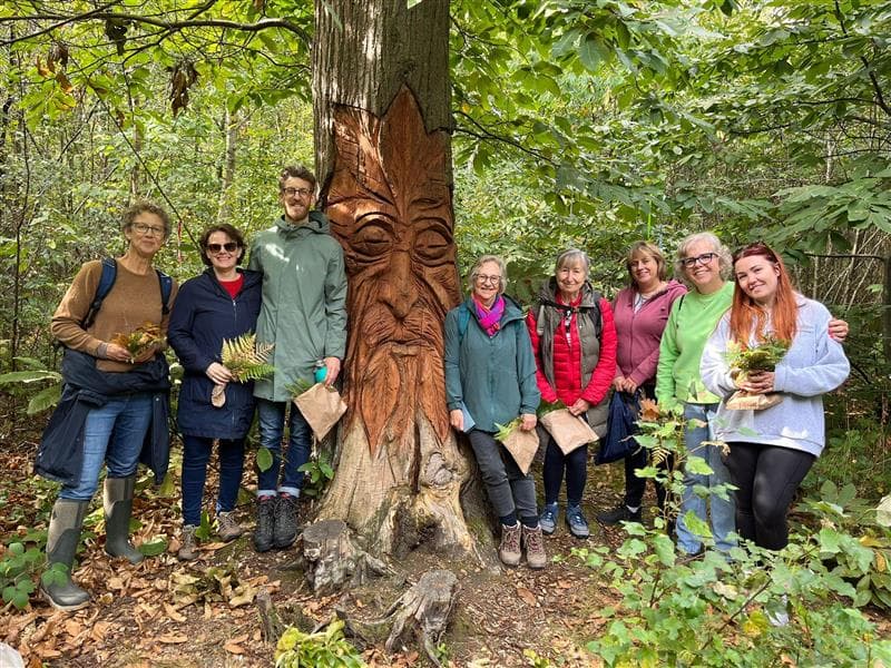 A group of people standing around a tree