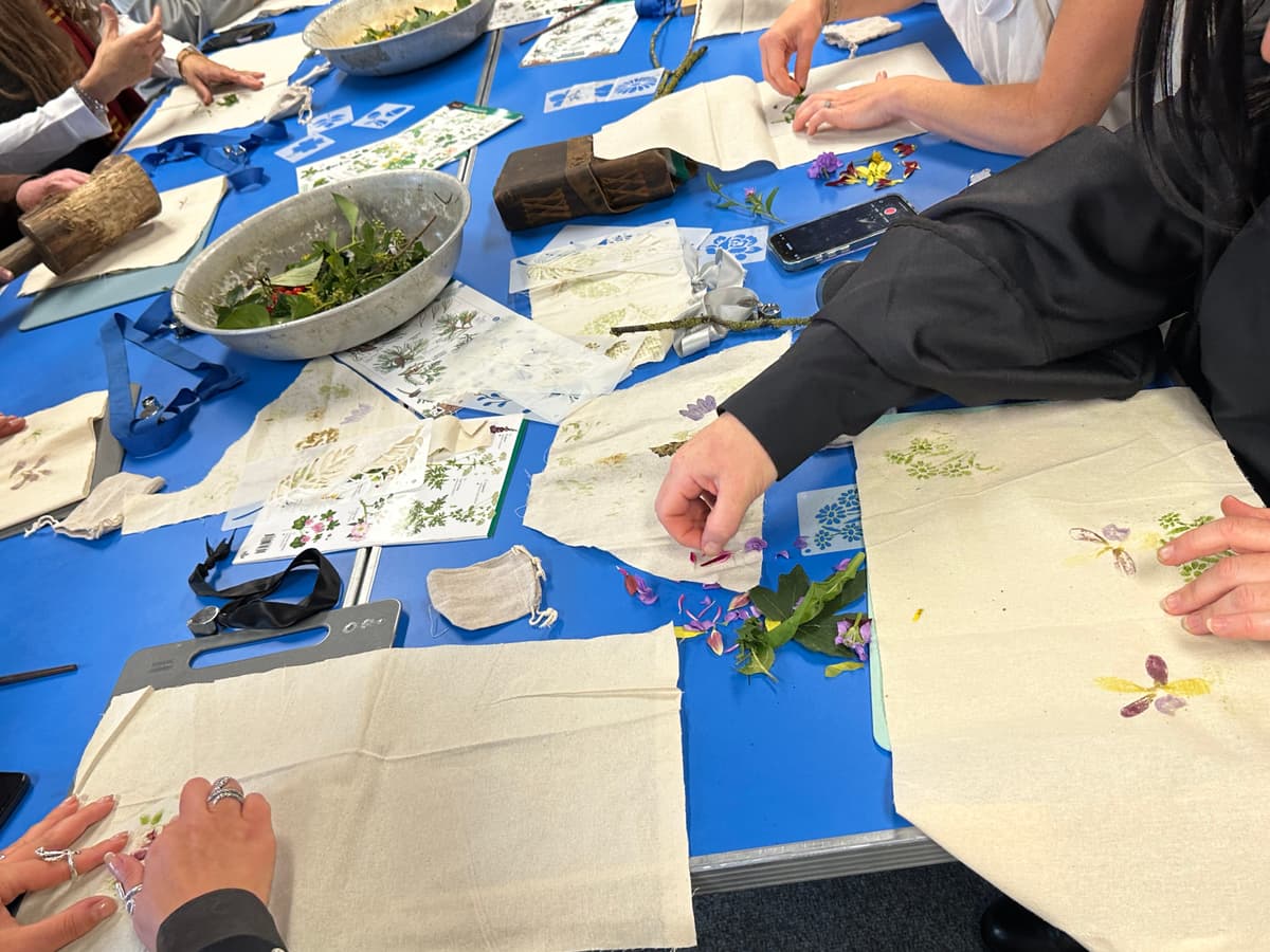 A group of people sitting at a table working on crafts